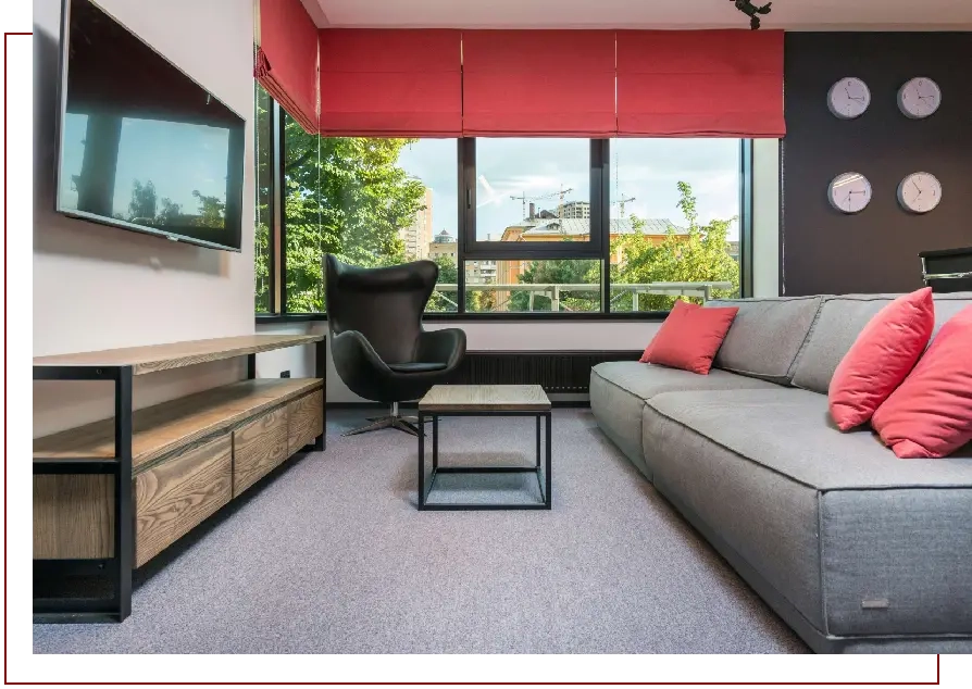 A living room with a couch and television.