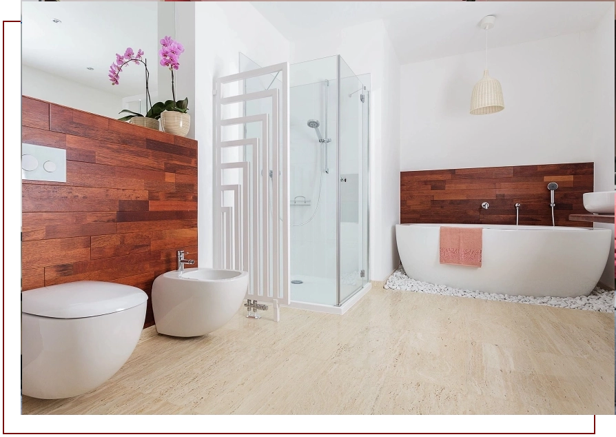 A bathroom with wood paneling and white fixtures.