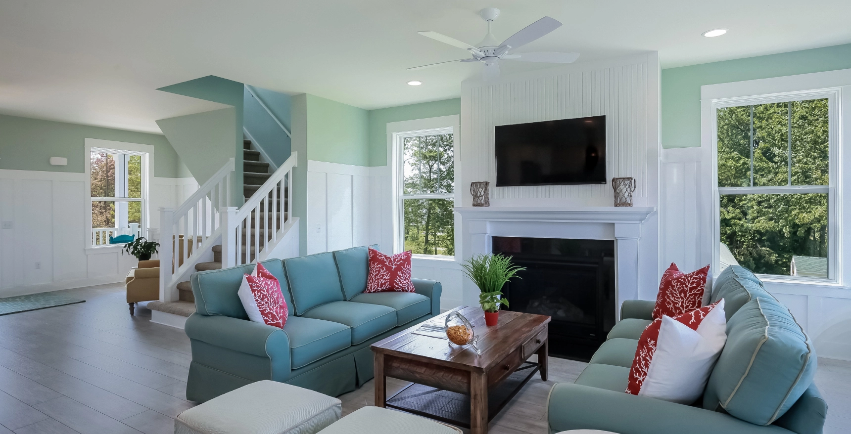 A living room with blue couches and a fireplace.