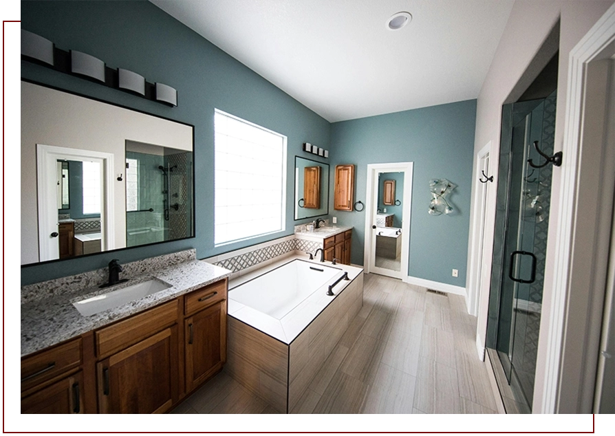 A bathroom with a large tub and a mirror.