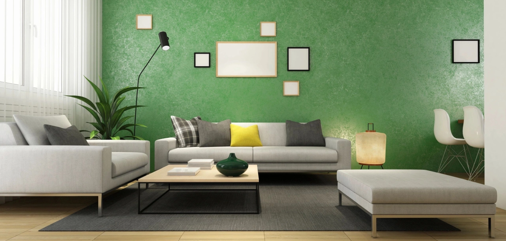 A living room with green walls and white furniture.