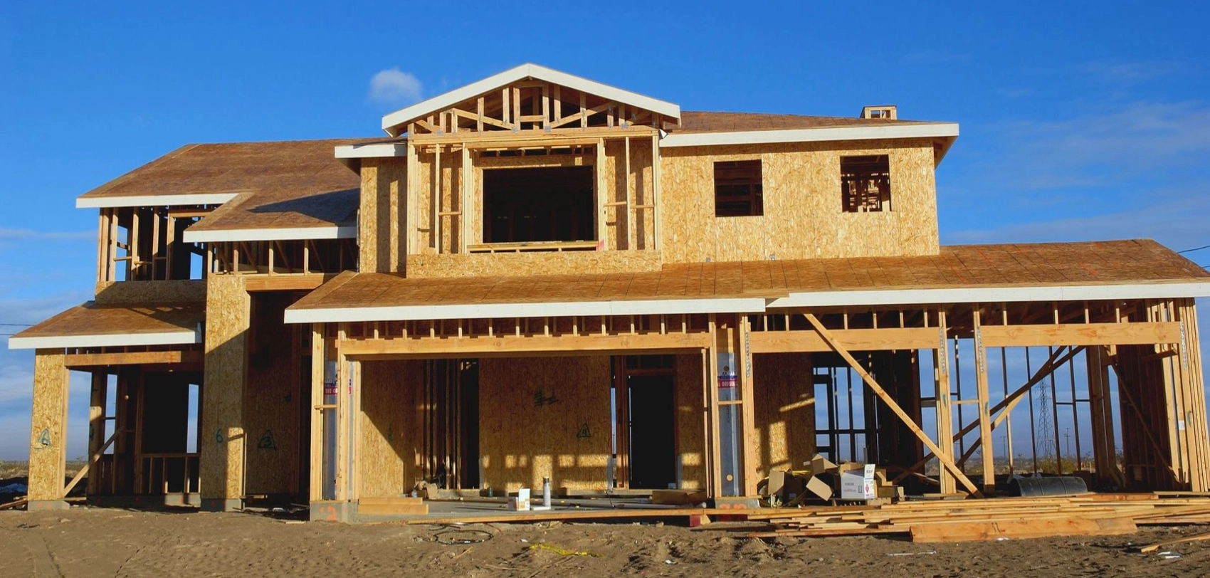 A house under construction with many windows and doors.